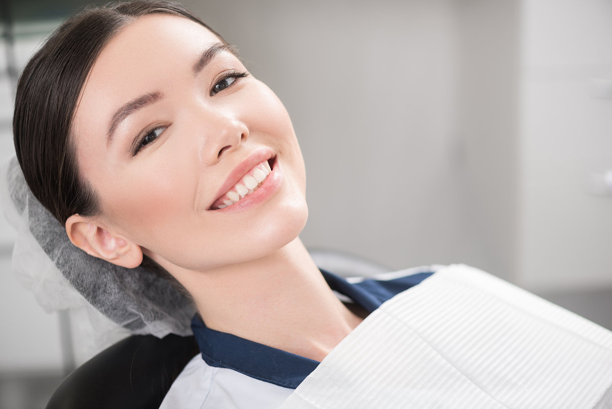 Portrait of cheerful woman leaning on cozy dental chair in apartment