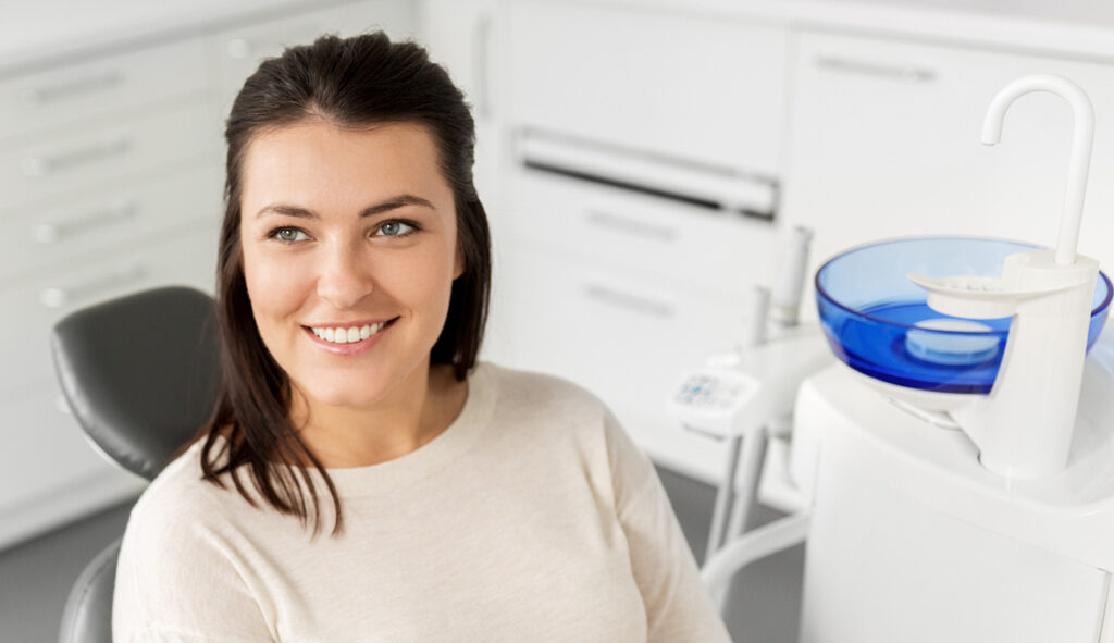 A smiling dark-haired girl at the dentist's office
