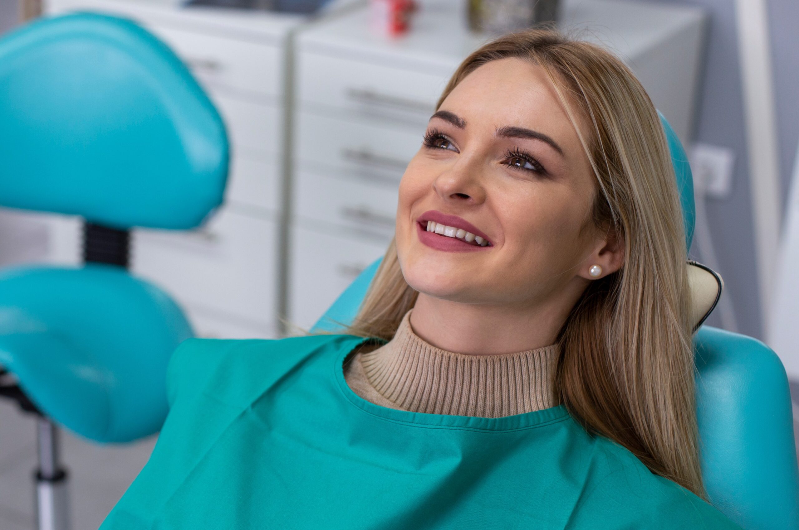 Patient in dental chair, relaxed.