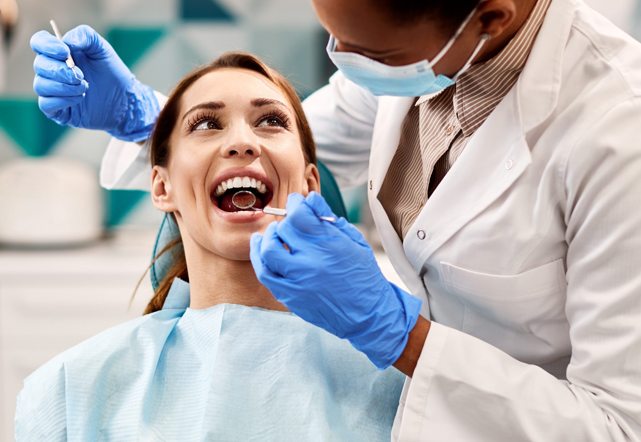 Happy woman having dental examination during appointment at dentist's office.